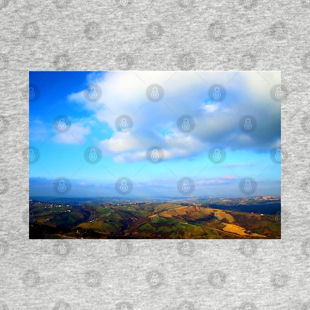 View from above on a hilly landscape under the blue sky with clouds by KristinaDrozd